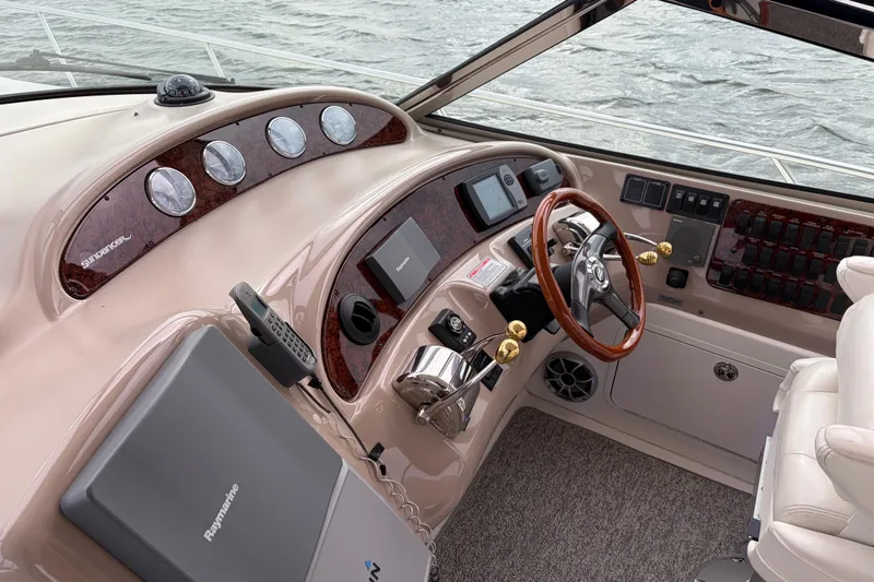Slide: The Image of 2004 Sea Ray Sundancer 460 helm with wood accents and modern navigation equipment. - 21