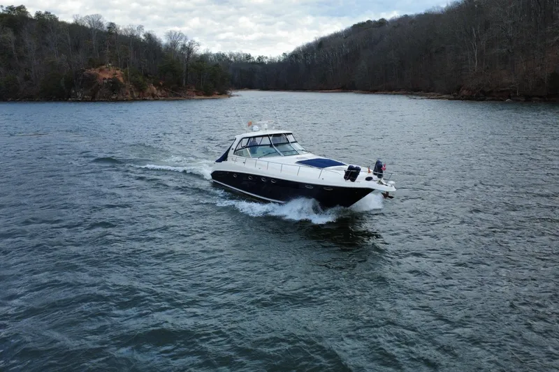 Slide: The Image of 2004 Sea Ray Sundancer 460 cruising on a scenic lake with wooded shoreline. - 5
