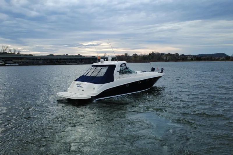 Slide: The Image of 2004 Sea Ray Sundancer 460 yacht cruising on a calm lake under cloudy skies. - 9