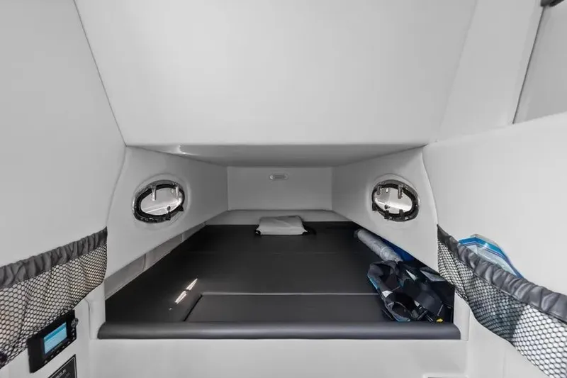 Slide: The Image of Interior cabin of 2023 Nor-Tech 390 Sport Center Console boat, featuring sleek design and storage. - 15