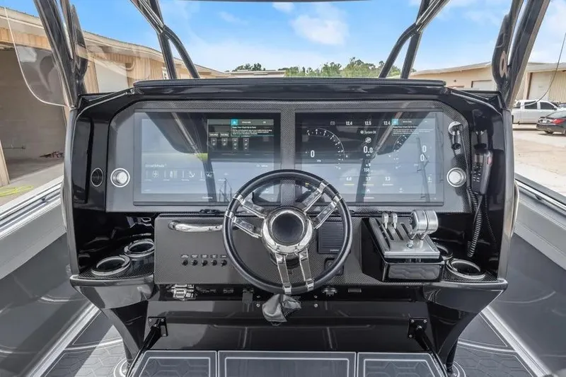 Slide: The Image of 2023 Nor-Tech 390 Sport Center Console dashboard with advanced controls and digital displays. - 6