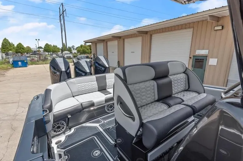 Slide: The Image of 2023 Nor-Tech 390 Sport Center Console boat with luxurious seating and powerful engines. - 9