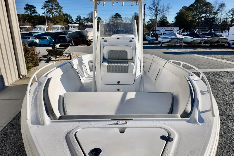 Slide: The Image of 2025 ALK2 Powerboats 23 CRX, sleek white interior, parked in a marina. - 12