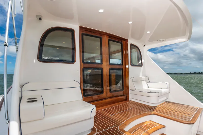 Slide: The Image of 2019 Jarrett Bay 67 Custom yacht with elegant wood finish and seating area. - 11