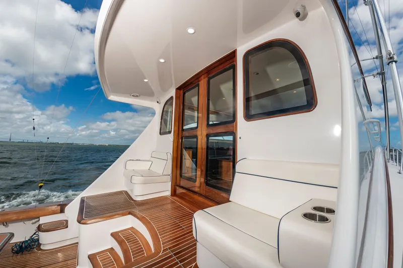 Slide: The Image of 2019 Jarrett Bay 67 Custom yacht with elegant wood finish and seating area. - 12