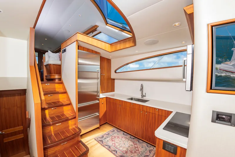 Slide: The Image of Interior of 2019 Jarrett Bay 67 Custom yacht, featuring modern kitchen and staircase. - 25