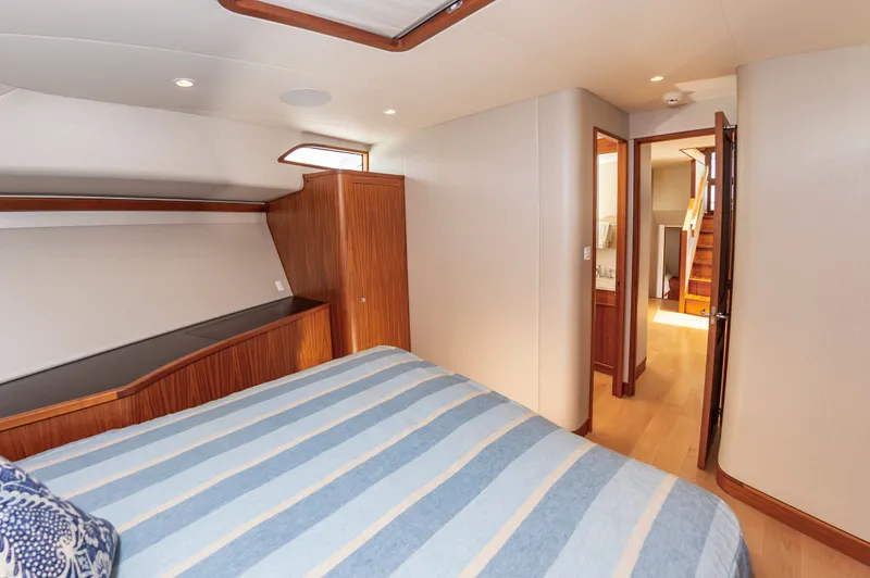 Slide: The Image of Interior of Jarrett Bay 67 Custom yacht, bedroom with wood furnishings, 2019 model. - 34