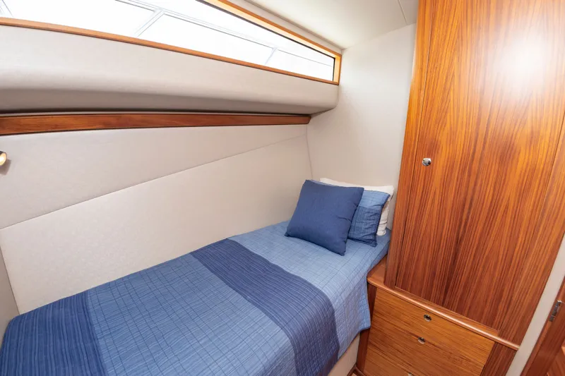 Slide: The Image of Interior of 2019 Jarrett Bay 67 Custom yacht with single bed and wooden cabinet. - 39