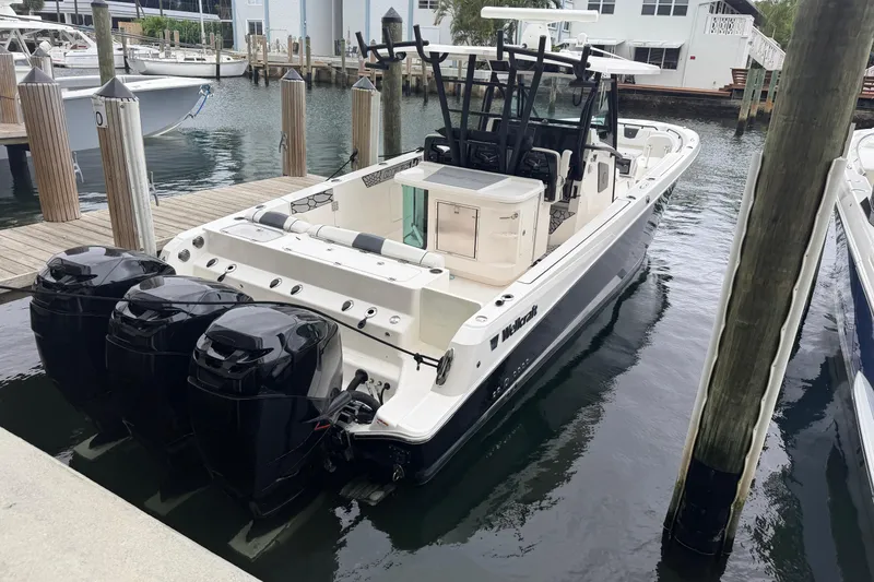 Slide: The Image of 2019 Wellcraft 352 Fisherman boat docked with triple outboard engines. - 6