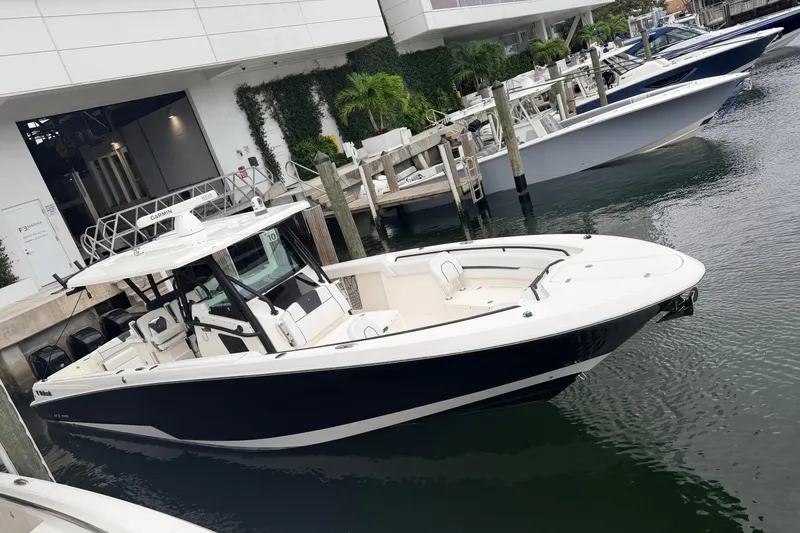 Slide: The Image of 2019 Wellcraft 352 Fisherman boat docked at a marina, sleek design and modern features. - 8