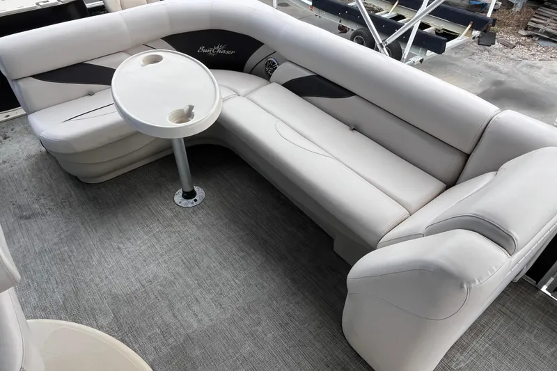 Slide: The Image of 2016 SunChaser Classic Fish 8522 Cruise-N-Fish boat interior with plush seating and table. - 18