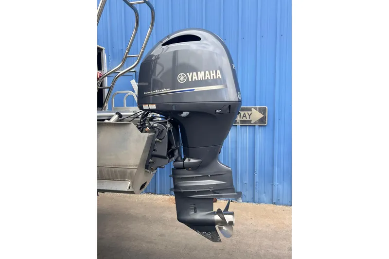 Slide: The Image of 2016 SunChaser Classic Fish 8522 with Yamaha outboard motor against blue wall. - 3