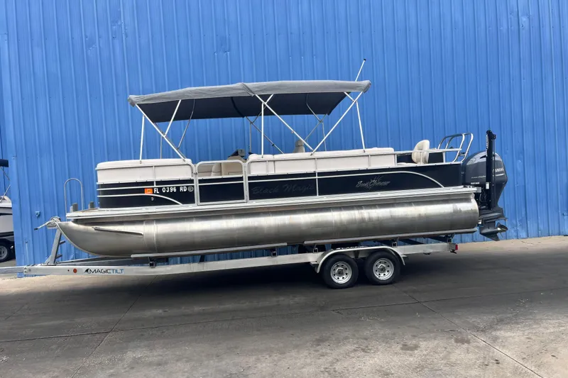Slide: The Image of 2016 SunChaser Classic Fish 8522 Cruise-N-Fish pontoon boat on trailer, blue background. - 5