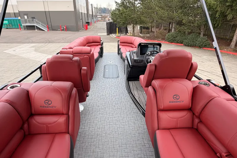 Slide: The Image of Luxurious 2026 Regency 250 DL pontoon boat with red leather seating and modern dashboard. - 4