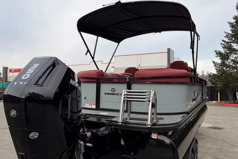 Slide: The Image of 2026 Regency 250 DL pontoon boat with Mercury 350 V10 engine, docked outdoors. - 8