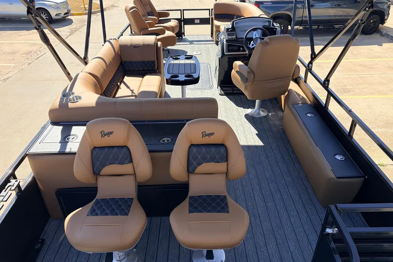 Slide: The Image of 2026 Ranger 223FC boat interior with tan seating and modern steering console. - 10