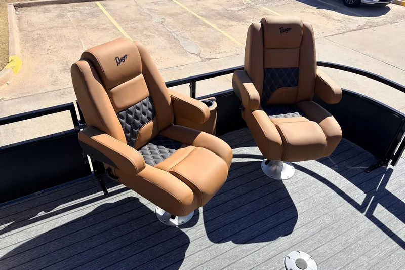 Slide: The Image of Luxurious seating on 2026 Ranger 223FC boat, featuring tan and black cushioned chairs. - 12