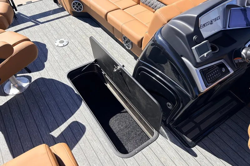Slide: The Image of 2026 Ranger 223FC boat interior with open storage compartment and luxurious seating. - 20