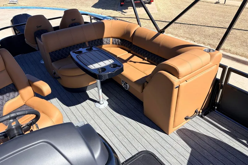 Slide: The Image of 2026 Ranger 223FC boat interior with tan leather seating and a central table. - 21