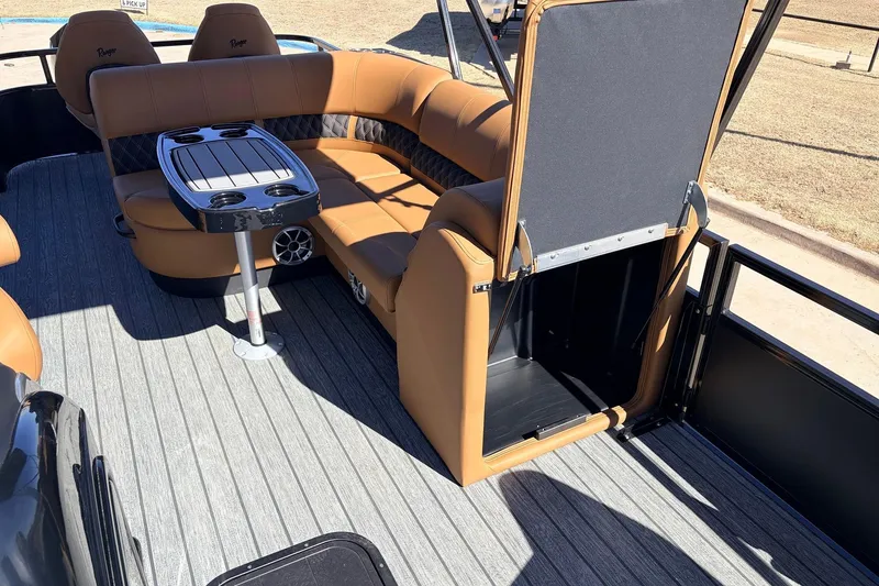 Slide: The Image of 2026 Ranger 223FC boat interior with tan seating and table, featuring cup holders. - 22