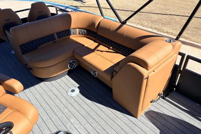 Slide: The Image of Luxurious seating on 2026 Ranger 223FC boat with tan upholstery and cup holders. - 23