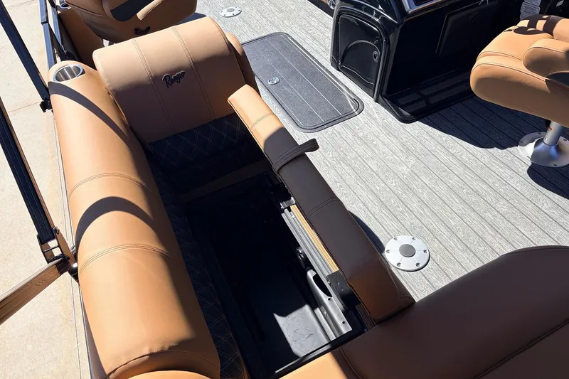 Slide: The Image of 2026 Ranger 223FC boat interior with tan seating and storage compartment. - 24