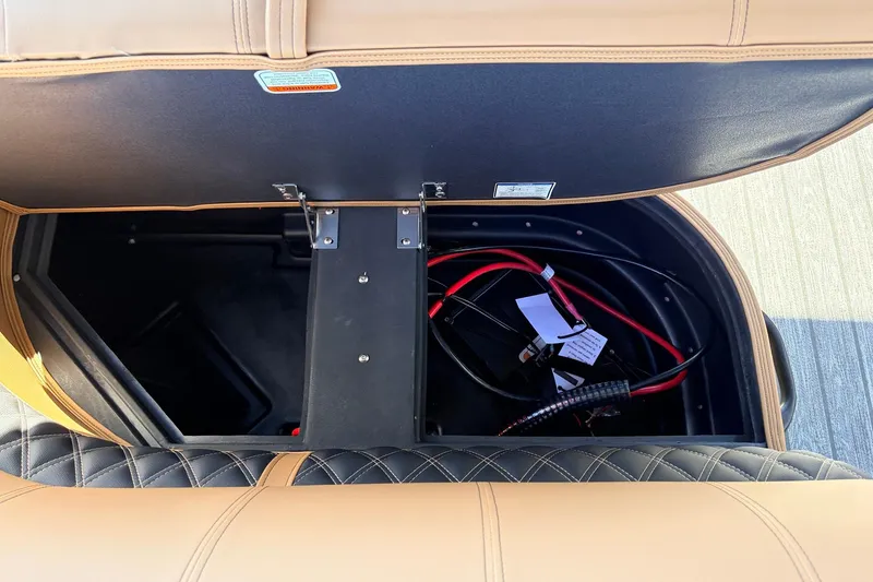 Slide: The Image of Open storage compartment in 2026 Ranger 223FC boat, showing wiring and interior details. - 26
