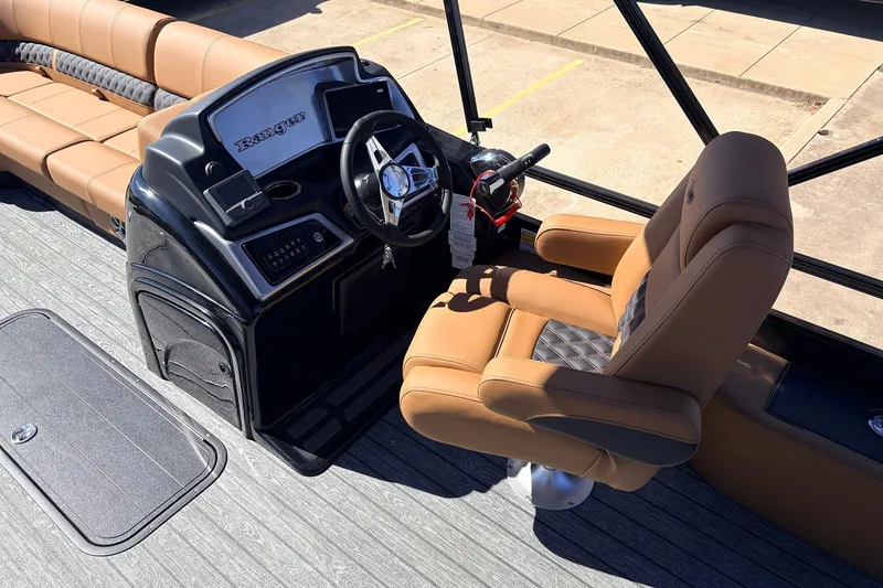 Slide: The Image of 2026 Ranger 223FC boat interior with tan seating and modern steering console. - 27
