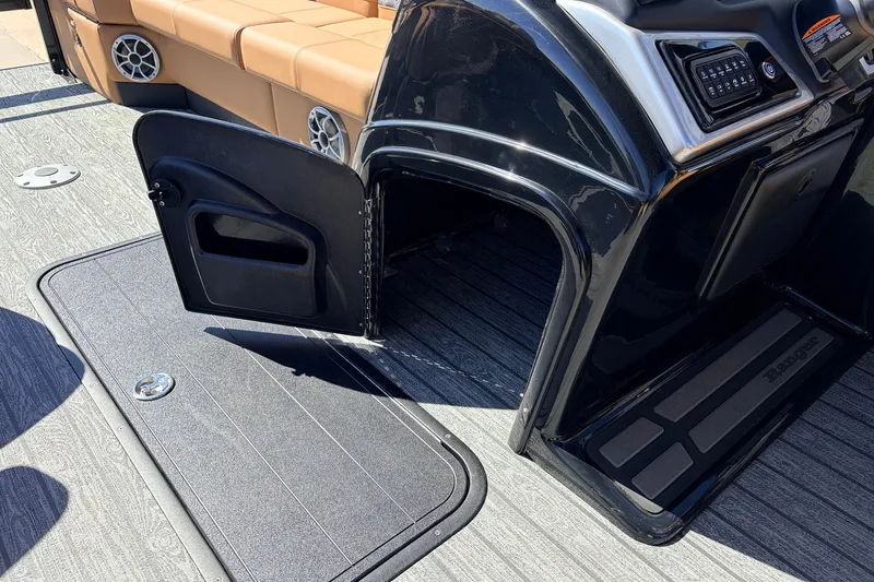 Slide: The Image of 2026 Ranger 223FC boat interior with open storage compartment and tan seating. - 29