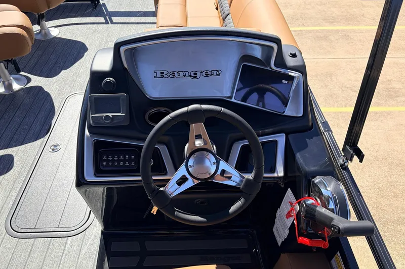 Slide: The Image of 2026 Ranger 223FC boat dashboard with steering wheel and control panel. - 32
