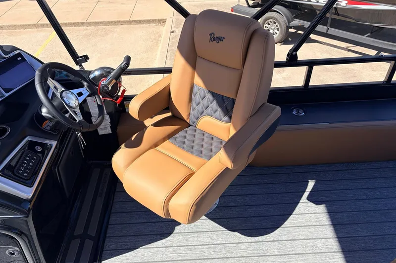Slide: The Image of Captain's chair in 2026 Ranger 223FC boat, featuring tan and black upholstery. - 35