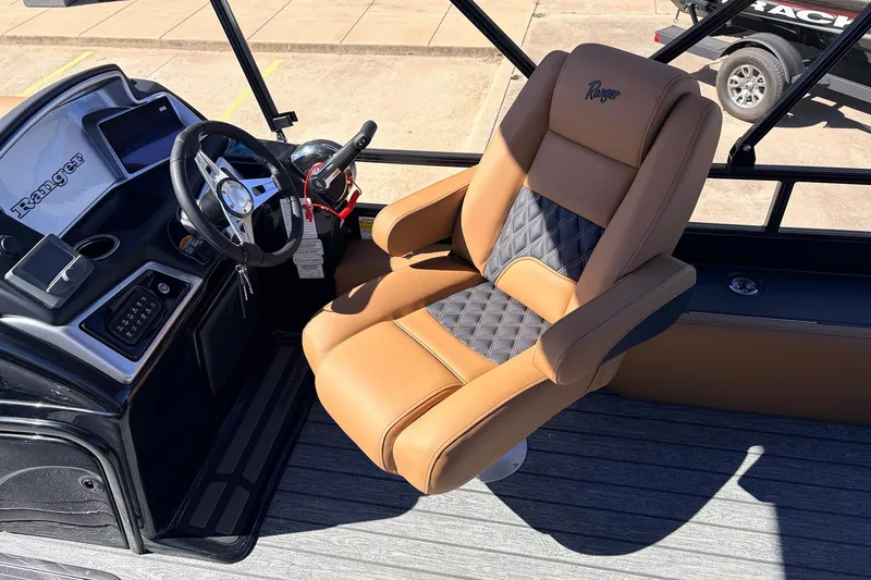 Slide: The Image of Captain's chair and console of 2026 Ranger 223FC boat, featuring luxurious seating and controls. - 36