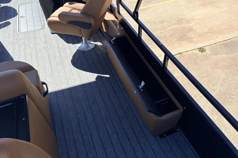 Slide: The Image of 2026 Ranger 223FC boat interior with tan seats and storage compartment. - 38