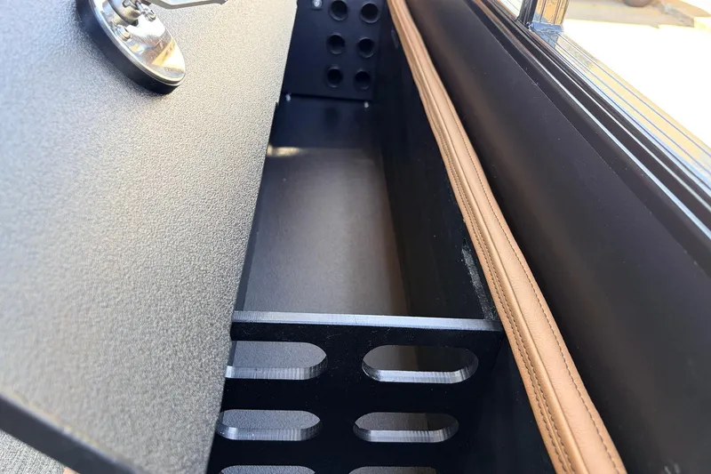 Slide: The Image of Interior storage compartment of 2026 Ranger 223FC with leather trim and metal detailing. - 39