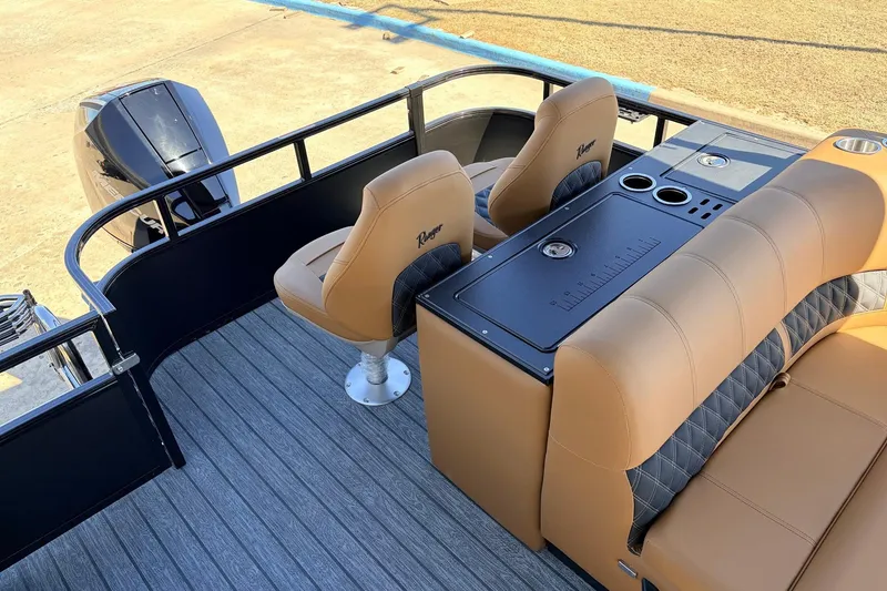Slide: The Image of 2026 Ranger 223FC boat interior with tan seating and modern console design. - 40