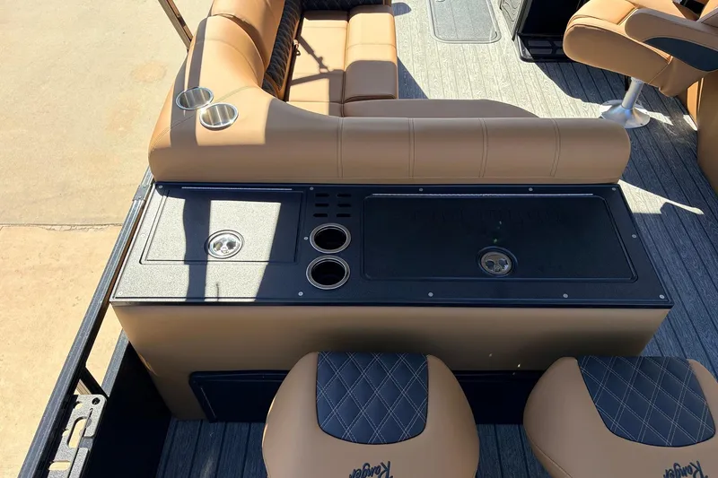Slide: The Image of 2026 Ranger 223FC boat interior with tan seating and built-in cup holders. - 43