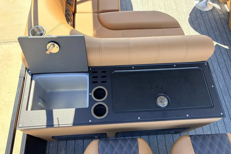 Slide: The Image of 2026 Ranger 223FC boat interior with sink, cup holders, and tan seating. - 44