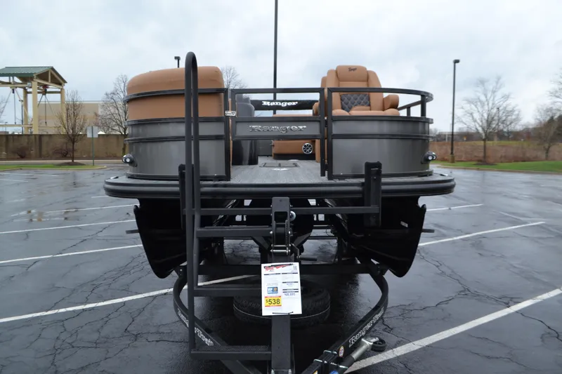 Slide: The Image of 2026 Ranger 223FC pontoon boat on trailer in parking lot. - 2