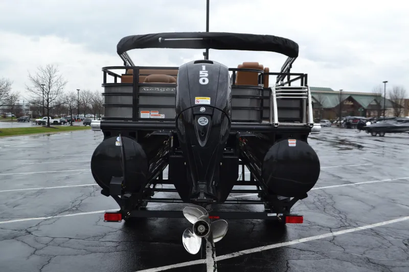 Slide: The Image of Rear view of 2026 Ranger 223FC boat with powerful outboard motor in parking lot. - 3