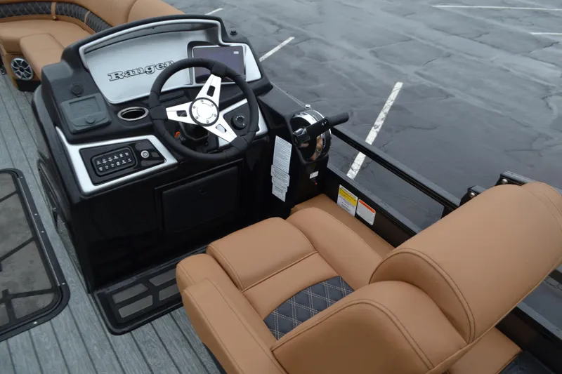 Slide: The Image of 2026 Ranger 223FC boat dashboard with tan seating and modern controls. - 4