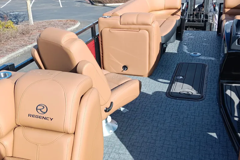 Slide: The Image of Luxurious seating on 2026 Regency 230 DL boat with tan upholstery and spacious layout. - 10