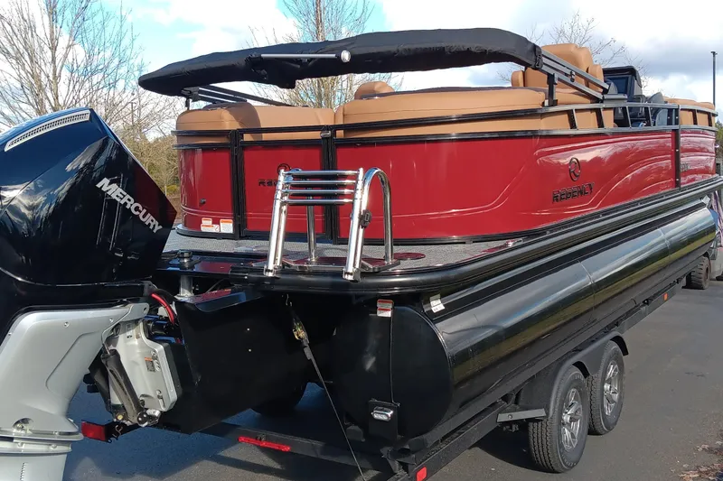Slide: The Image of 2026 Regency 230 DL pontoon boat with Mercury engine, red and black design. - 4