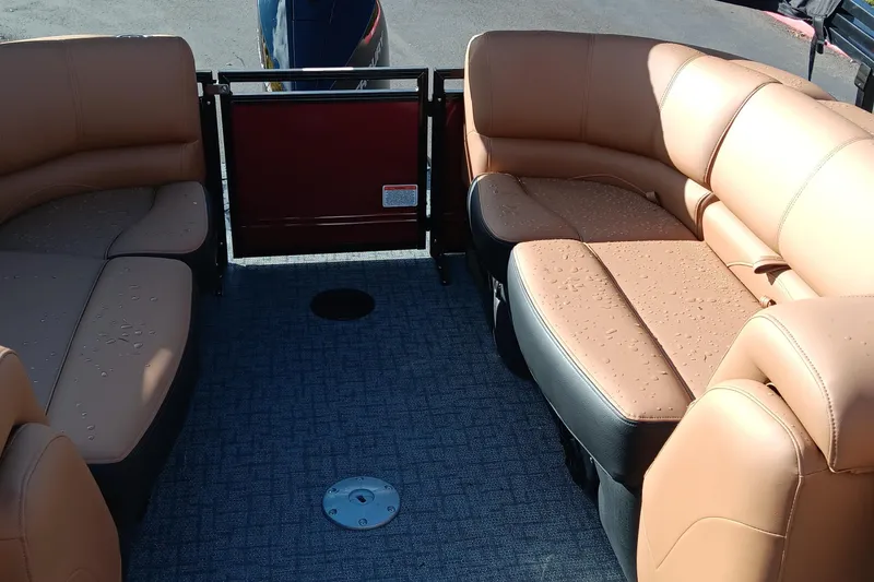 Slide: The Image of Luxurious seating on 2026 Regency 230 DL boat, featuring tan leather upholstery and spacious layout. - 7