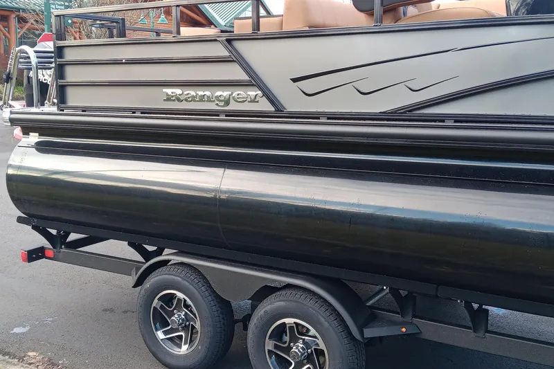 Slide: The Image of 2026 Ranger 223FC pontoon boat on trailer, showcasing sleek design and modern features. - 2