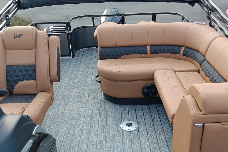Slide: The Image of 2026 Ranger 223FC boat interior with tan and black seating, featuring a modern design. - 5