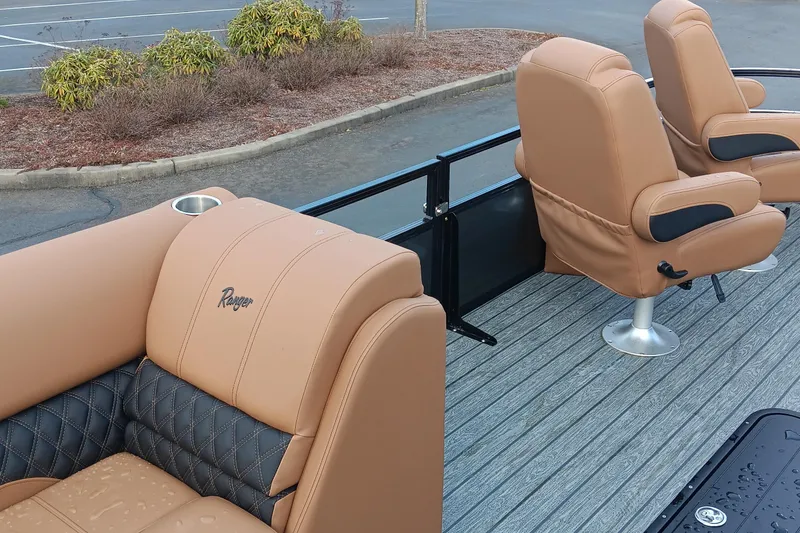 Slide: The Image of 2026 Ranger 223FC boat interior with tan leather seats and cup holder. - 6