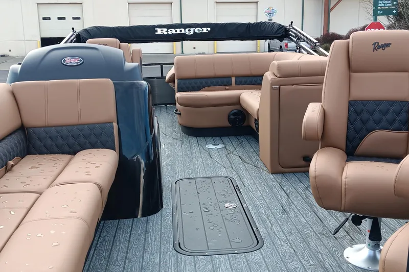 Slide: The Image of 2026 Ranger 223FC boat interior with tan and black seating, wet deck, and modern design. - 7