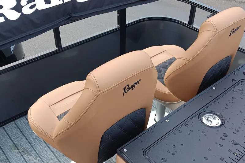 Slide: The Image of 2026 Ranger 223FC boat seats with tan upholstery and black accents, featuring brand logo. - 8