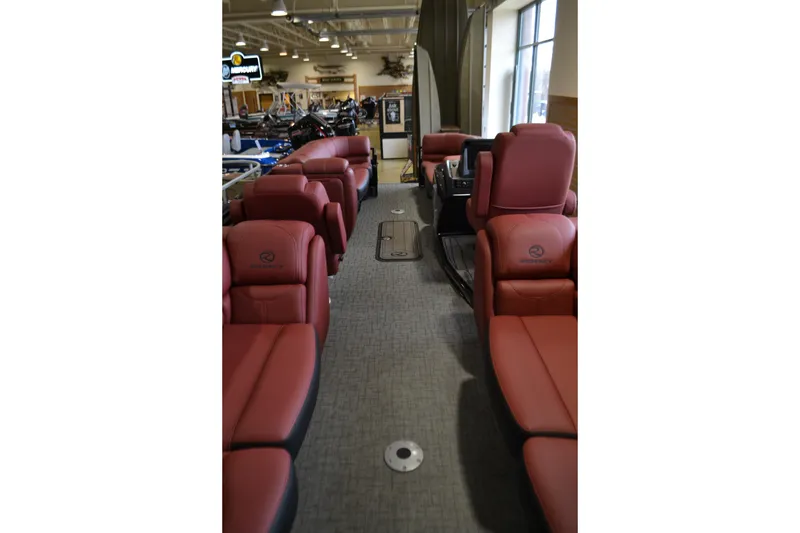 Slide: The Image of 2026 Regency 230 DL boat with Mercury engine displayed indoors. - 2