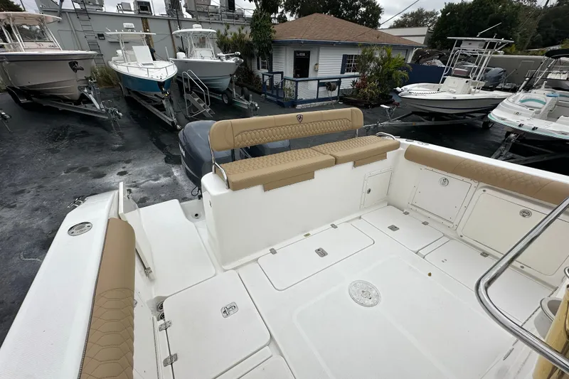 Slide: The Image of 2007 Century 3200 Center Console boat interior with tan seating, docked among other boats. - 10